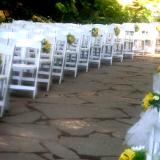 Line of chairs decorated with same flowers